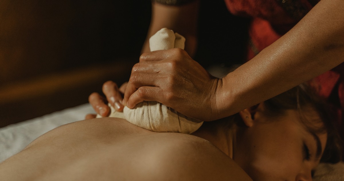 Luk Pra Kob herbal compress massage at Siam Soul Auckland — steamed Thai herbal bundles applied to back